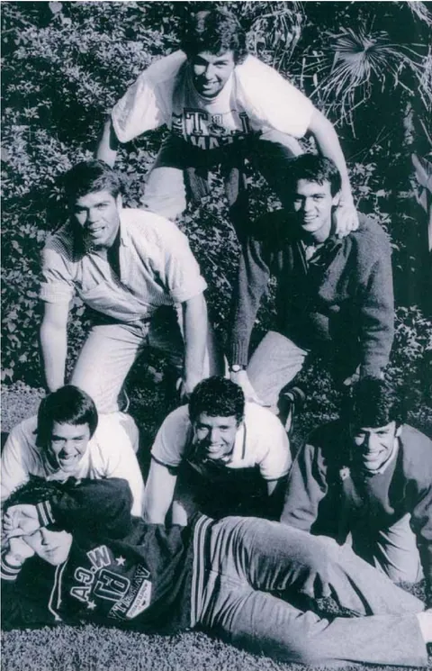 Guillermo with a group of friends, in black and white