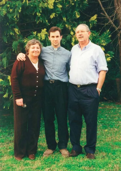 Guillermo with his parents, Carola and Carlos, in a garden